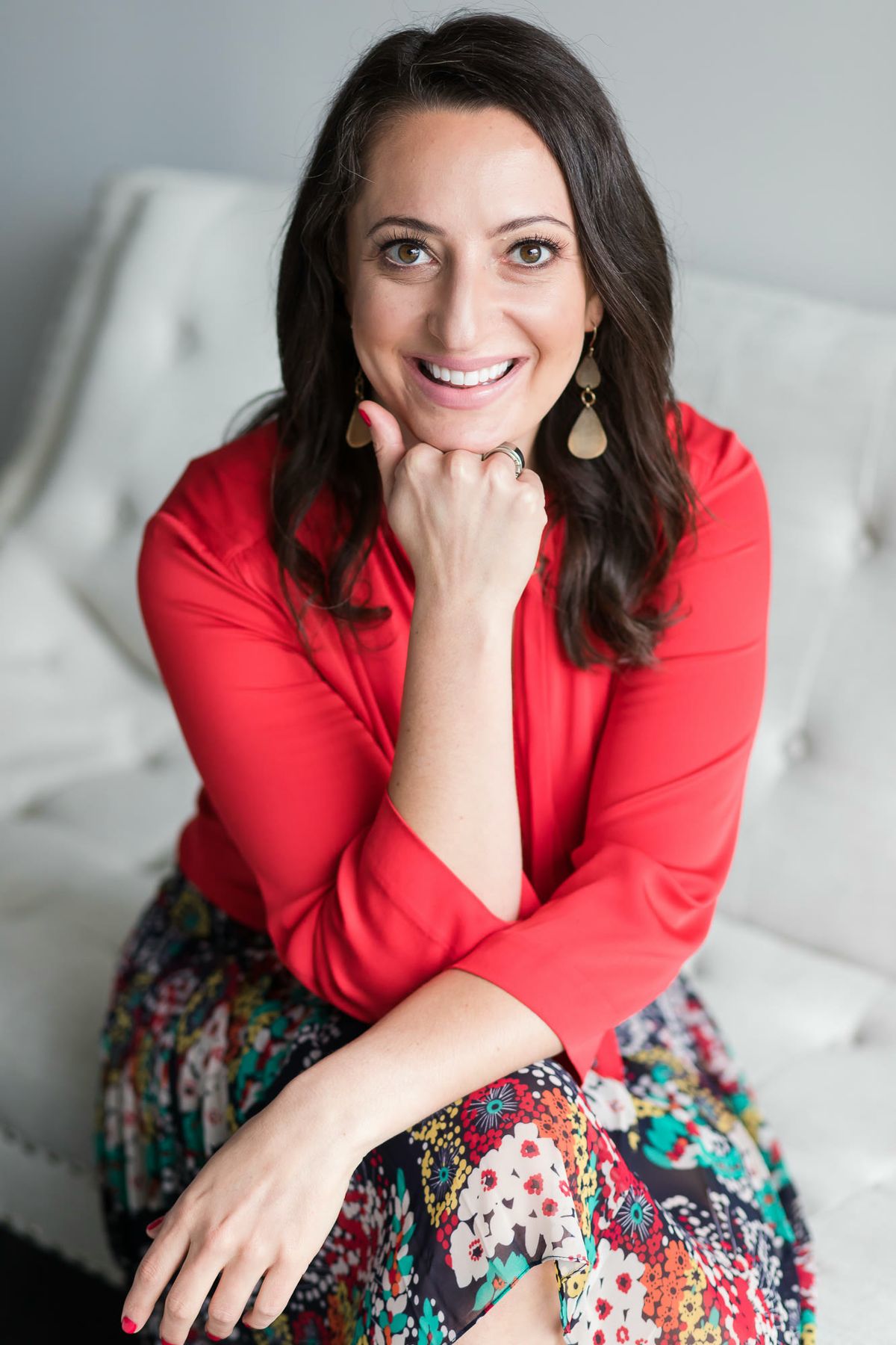 Lauren Goldstein smiling, seated with her chin resting on her hand